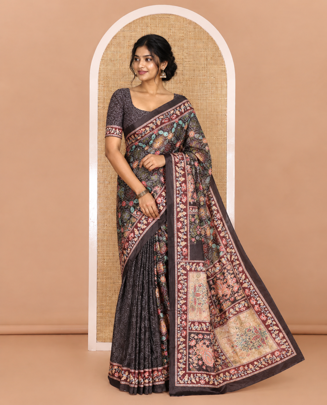 Black bandhani printed and mirror work masakali saree, floral creeper printed border, pallu of floral-peacock print, and a matching blouse