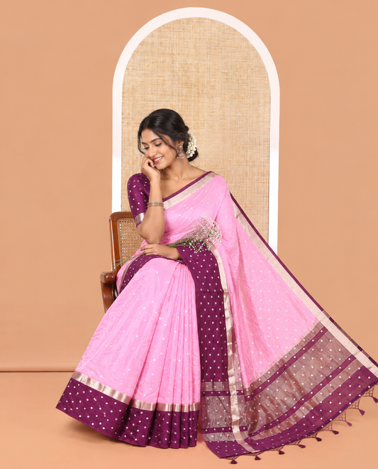Pink Assam Silk Saree, Masterfully Woven with Zari Buttas on Its Body, Complemented by Contrast Border Steeped with Zari Buttas, Pallu Steeped with Gleaming Zari Stripes and Buttas, and Paired with a Contrast Blouse
