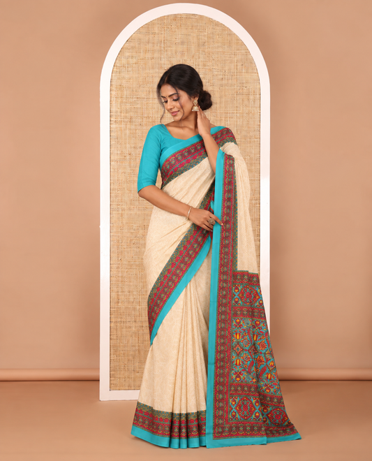 Cream leaf motifs printed crepe silk saree, contrast blue printed blouse, kaleidoscope coloured intricately printed border & pallu