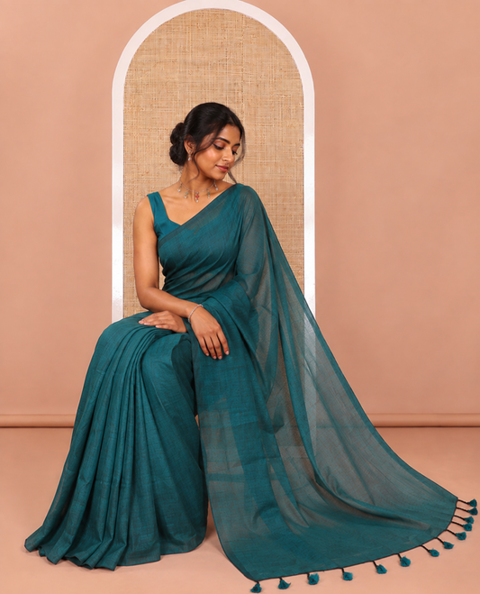 Borderless Rama Color Plain Khadi Mul Cotton Saree Features a Self-Pallu with Tassels, and a Matching Blouse
