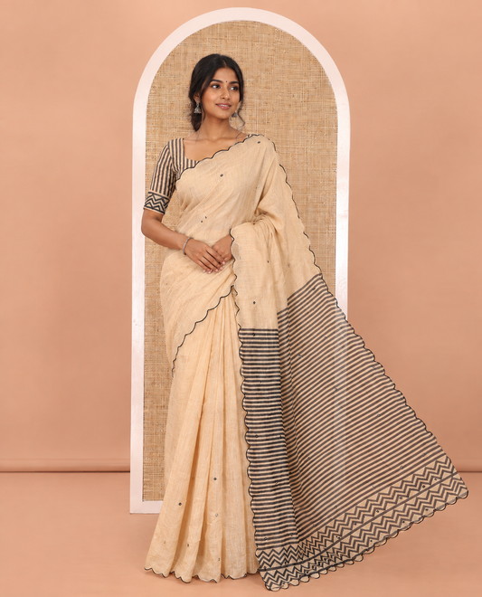 Chikku Linen Cotton Saree, Adorned with Mirror Work All Over Its Body, Subtly Scallop Border, Complemented by Contrast Pallu of Stripes and Mirror Work, and Paired with a Contrast Geometric Printed Blouse