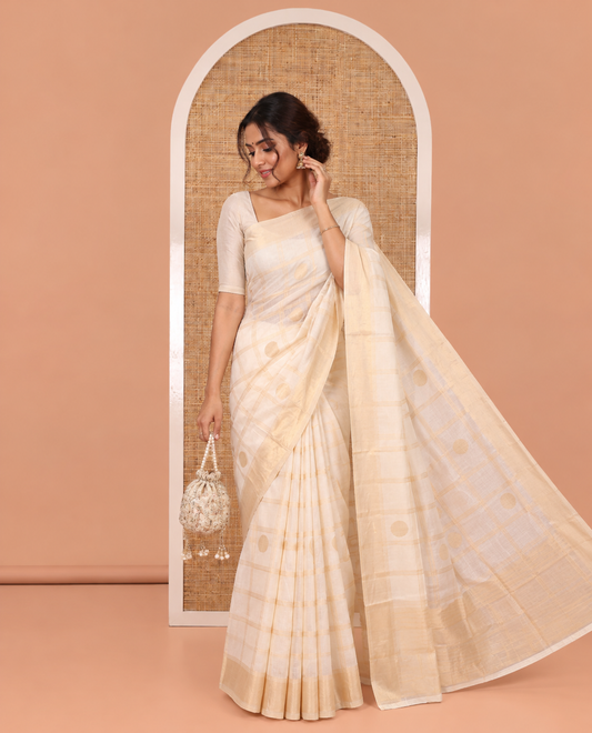 Cream Chanderi Cotton Saree Features Polka Dot Enclosed Checks, a Zari Border, a Matching Blouse