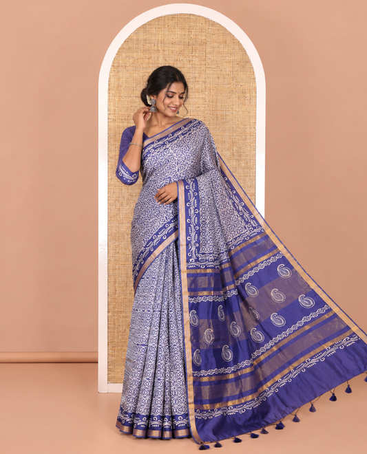 Blue geometric batik printed banana pith saree, printed piping border, paisley motifs steeped pallu, and a matching blouse