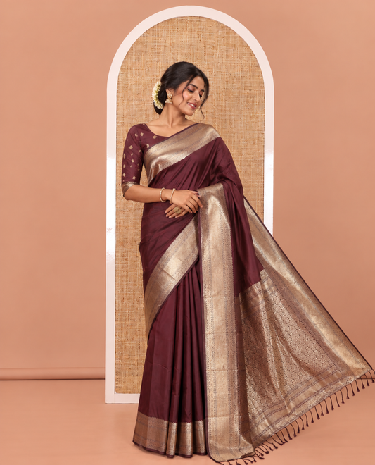 Maroon Plain Semi-Soft Silk Saree, Highlighted by Traditional Zari Designs Woven Border, Grandly Woven Pallu Steeped with Chakram Designs, and Paired with a Matching Blouse