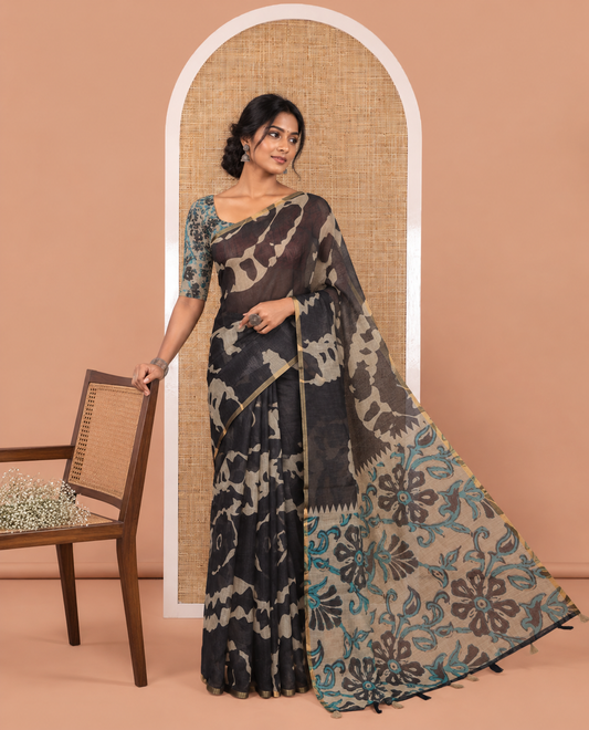 Black Linen Saree, Accentuated with Abstract-Style Print on Its Body, Subtle Piping Border, Captivating Pallu of Floral Vine Print, and Paired with a Contrast Floral Printed Blouse