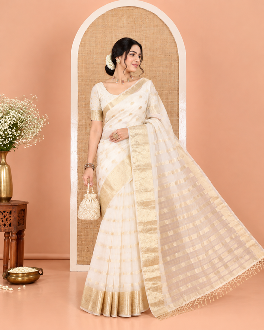 Cream Semi-Organza Saree, Shimmering with Zari Buttas All Over Its Body, Highlighted by a Traditional Zari Design Border, Gleaming Zari Design Pallu, and Paired with a Matching Blouse
