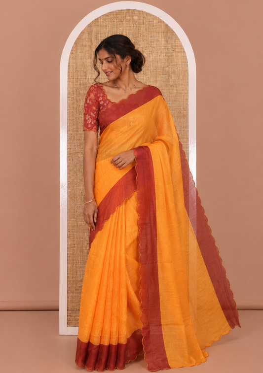 Yellow Plain Linen Cotton Saree, Complemented by Contrast Scallop Border, Plain Pallu, and Paired with a Contrast Floral Printed Mirror Embroidered Blouse