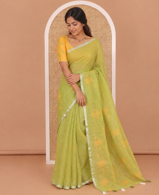 Green Pichwai lotus printed linen cotton saree, piping zari border, colorful tasselled lotus printed pallu, and a contrast lotus printed blouse