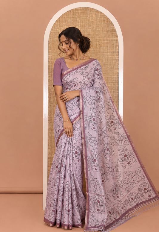 Light Mauve Linen Saree Creatively Printed with Girl Face and Floral Motifs All Over Its Body, Subtly Sparkled with Piping Zari Border, Pallu Mirrors the Same Body Print, and Paired with a Contrast Blouse