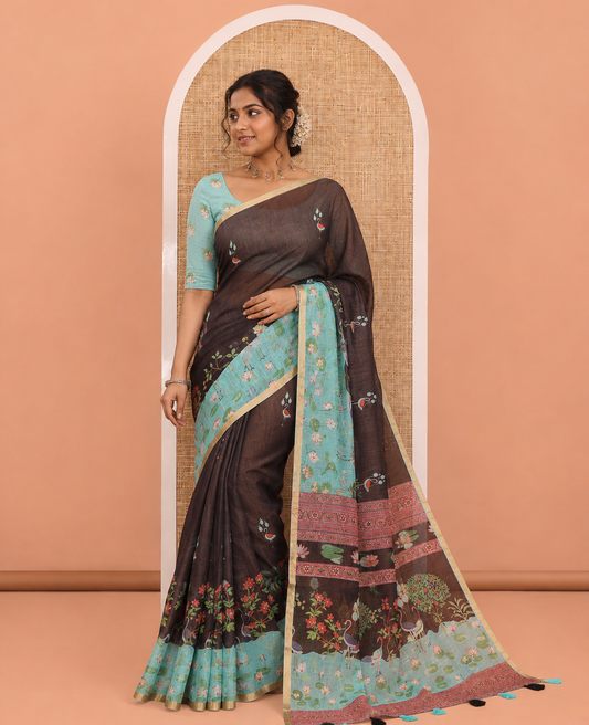 Black Linen Cotton Saree, Prettified with Crane and Floral Printed on Its Body, Subtle Piping Border, Captivating Contrast Pallu of Floral, Pichwai Lotus and Bird Designs, and Paired with a Contrast Blouse