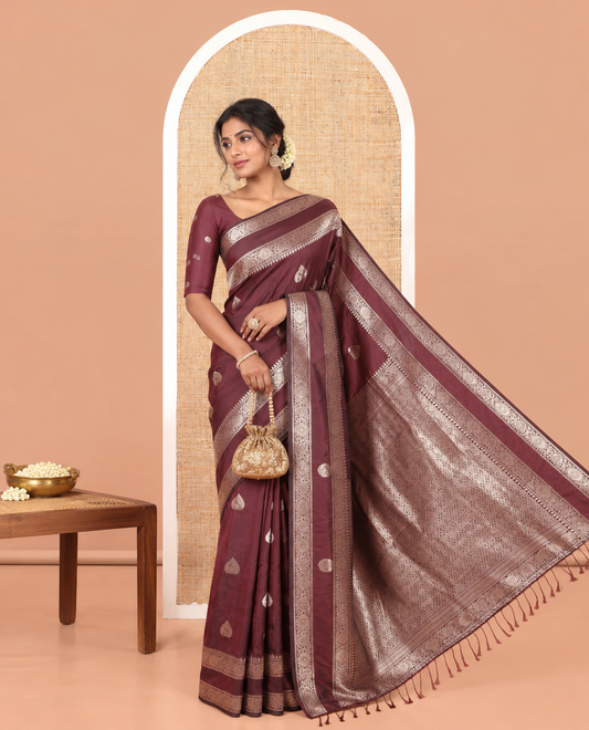 Brown Kanchi Soft Silk Saree, Elevated with Zari Buttas All Over Its Body, Highlighted by Traditional Zari Rettai Pettu Chakram Border, Intricately Designed Jaal Pallu, and Paired with a Matching Blouse