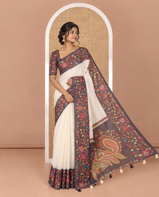 Cream plain linen cotton saree, contrast colorful floral vine printed border with mirror work, peacock printed pallu, and a contrast floral vine printed blouse