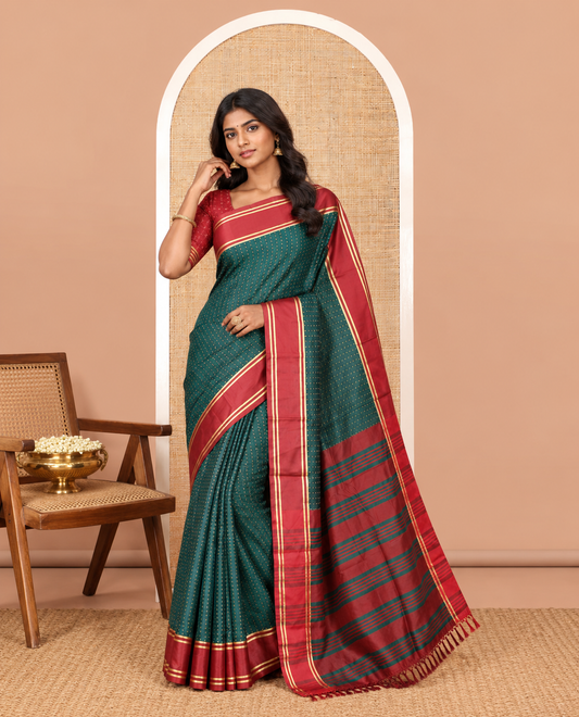 Bottle Green Semi-Soft Silk Saree Steeped with Plus-Shaped Buttas, Contrast Border, and a Matching Blouse