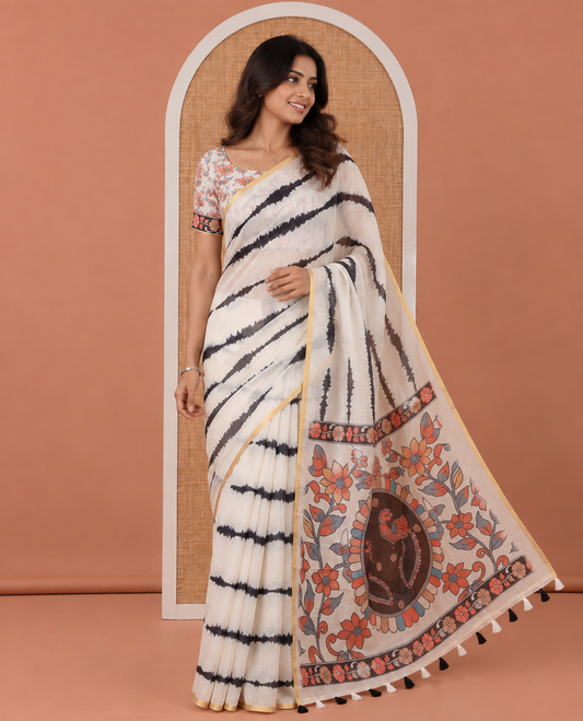 Cream Linen Cotton Saree, Adorned with Shibori Print, a Zari Piping Border, Floral-Peacock Motif Printed Pallu, and Matching Blouse