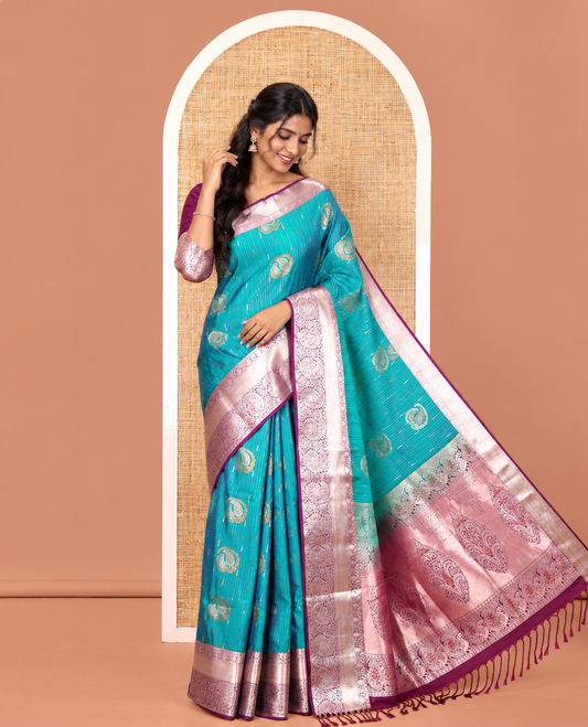 Ramar Blue Semi-Soft Silk Saree, Gracefully Embellished with Vaira Oosi, and Paisley Buttas All Over Its Body, Complemented by Contrast Traditional Border of Paisleys, Intricately Designed Pallu, and Paired with a Contrast Blouse