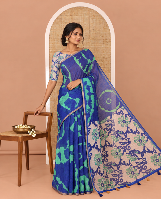 Navy Blue Linen Cotton Saree, Ornamented with Shibori Printed on Its Body, Subtle Piping Border, Pallu of Floral Vine Print, and Paired with a Contrast Floral Vine Printed Blouse