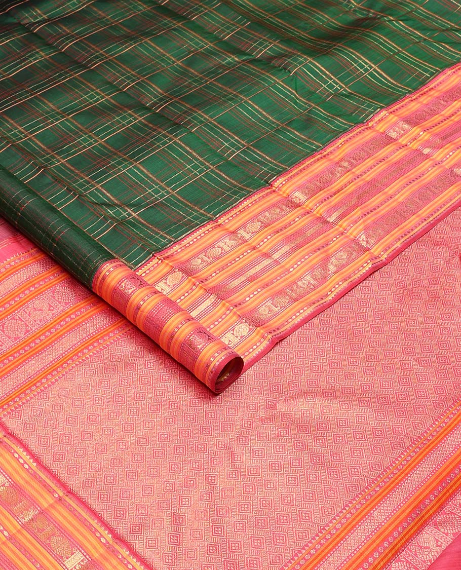 Green checked pure silk saree, contrast border of rekku, plus buttas, muthu, mayil kann, and mayil chakram designs, and zari-rich jaal pallu