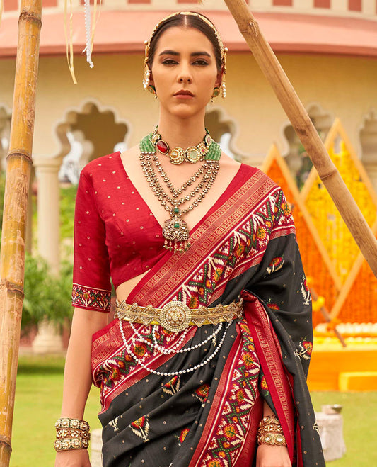 Black patola floral motifs printed designer saree, contrast intricate patola border, and floral motifs patola printed pallu