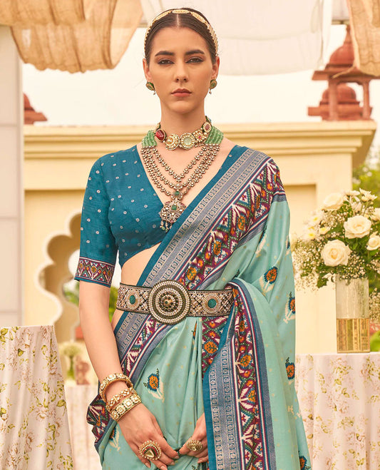 Turquoise patola floral motifs printed designer saree, contrast intricate patola border, and floral motifs patola printed pallu