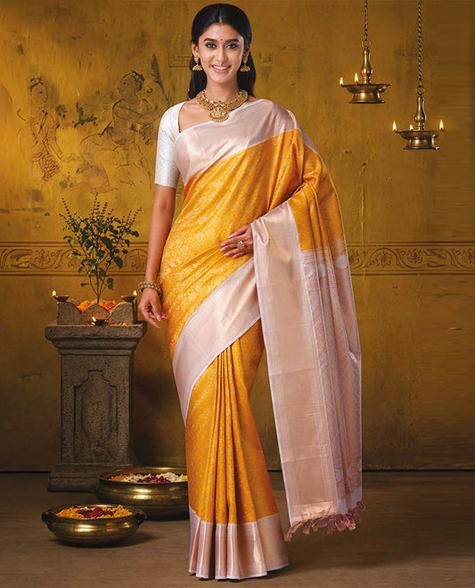 Yellow jacquard Kanchipuram wedding silk saree, zari border steeped with traditional designs, and jaal pallu